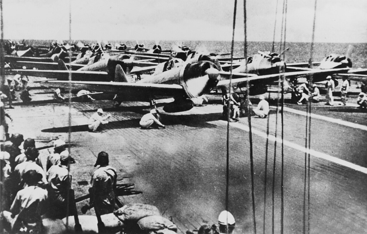 Japanese Mitsubishi A6M2 Zero fighters lined up on a carrier flight deck ready for take-off, probably aboard Shokaku on the morning of the Battle of the Santa Cruz Islands