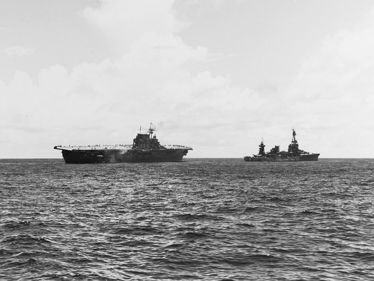 The heavy cruiser USS Northampton standing ahead of the damaged aircraft carrier USS Hornet as it attempts to take her in tow during the Battle of the Santa Cruz Islands