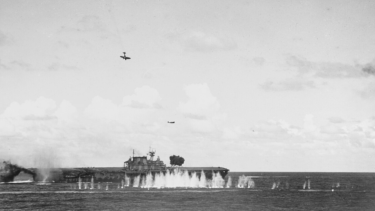 A Japanese Aichi D3A Val dive bomber dives on the US aircraft carrier USS Hornet amid anti-aircraft splashes during the Battle of the Santa Cruz Islands