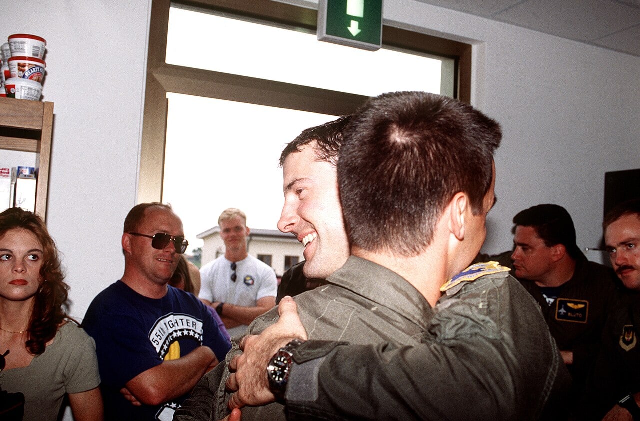 Scott O'Grady hugs a fellow pilot at Aviano