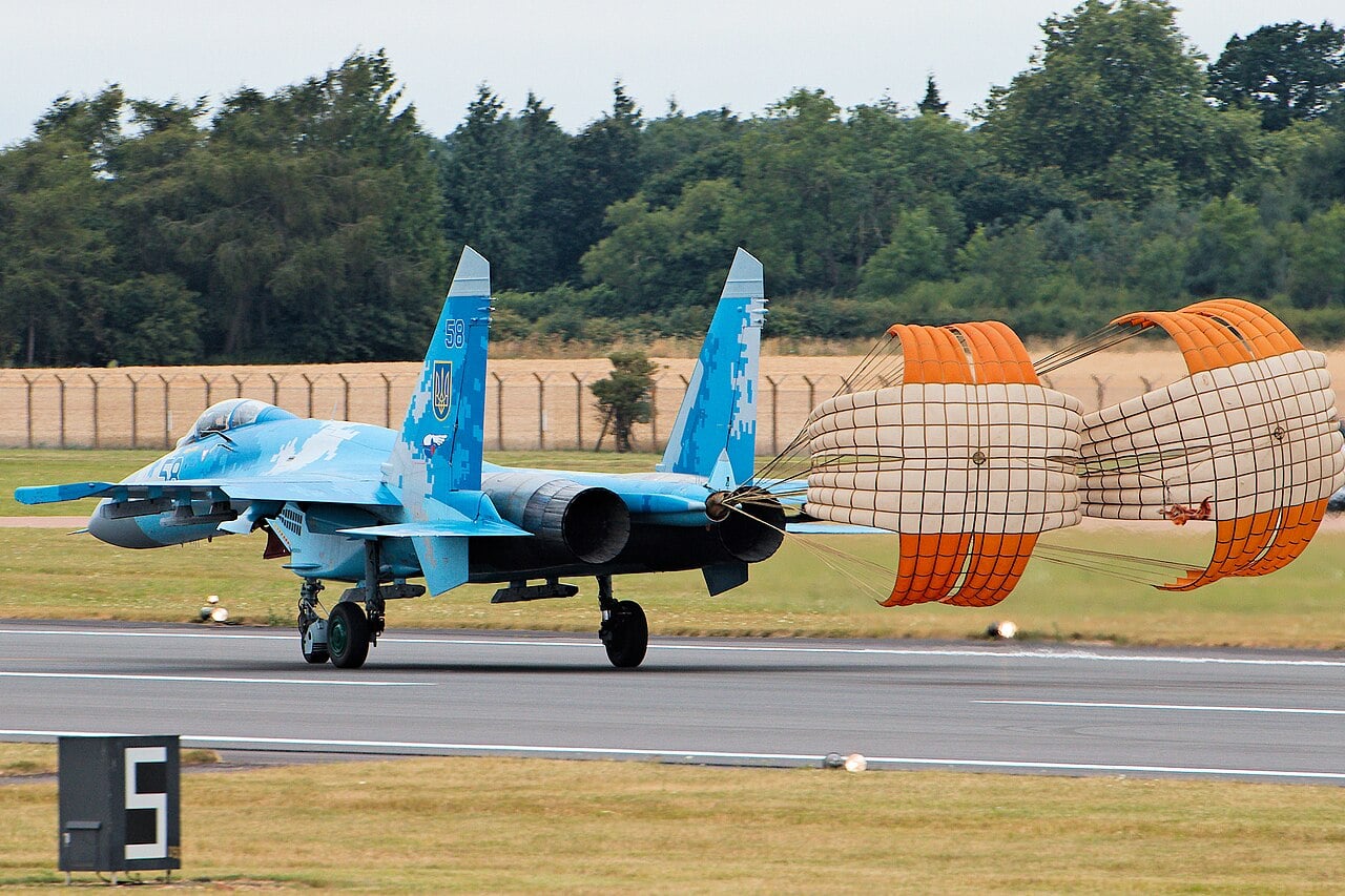 Ukrainian Air Force Su-27 landing with twin brake parachutes deployed from its tail stinger