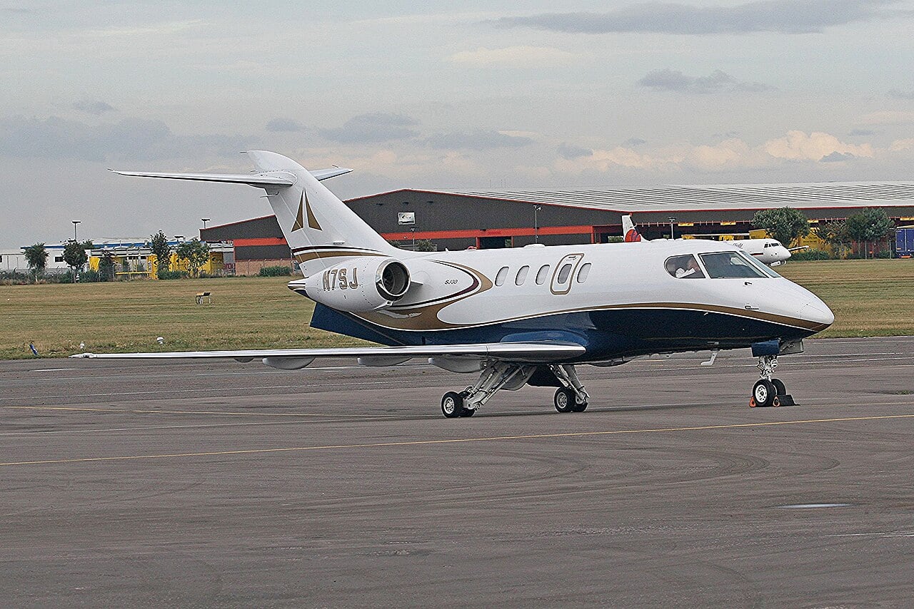 SJ30-2 business jet N7SJ parked on an apron at Coventry