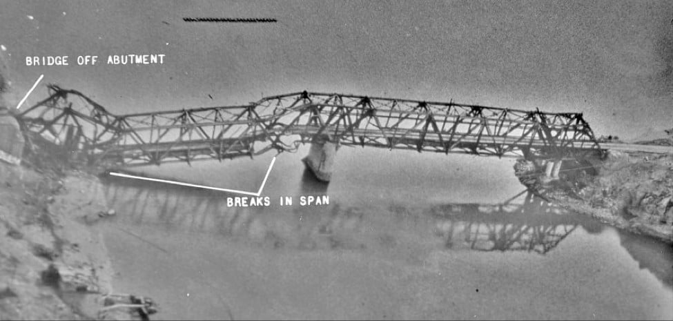 The Thanh Hoa Bridge with its western span knocked off the abutment and breaks in the span after laser-guided bomb strikes in 1972
