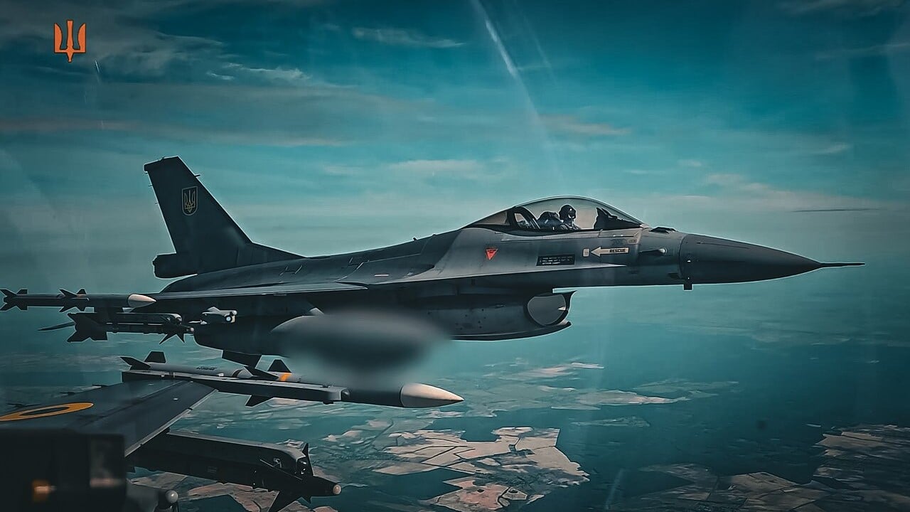 A Ukrainian Air Force F-16 Fighting Falcon armed with missiles flying over Ukraine, with a second F-16 wing in the foreground