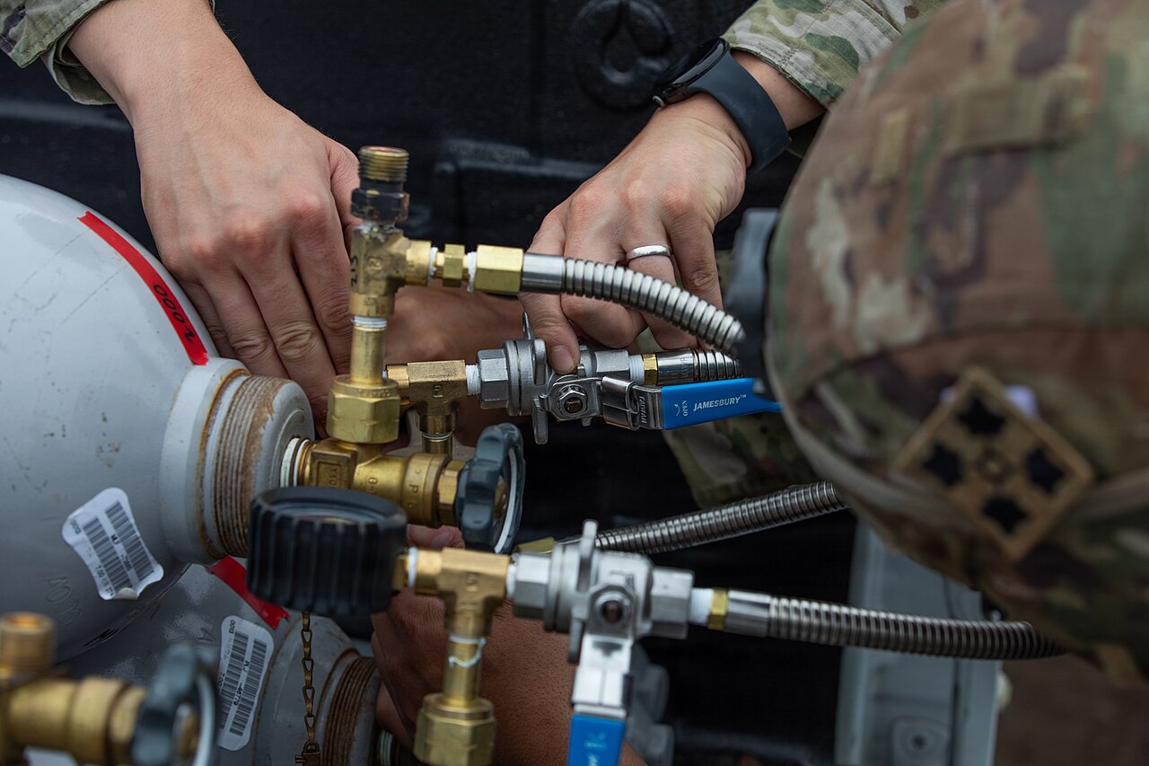 US Army soldiers fill a micro high-altitude balloon with helium during Orient Shield 26