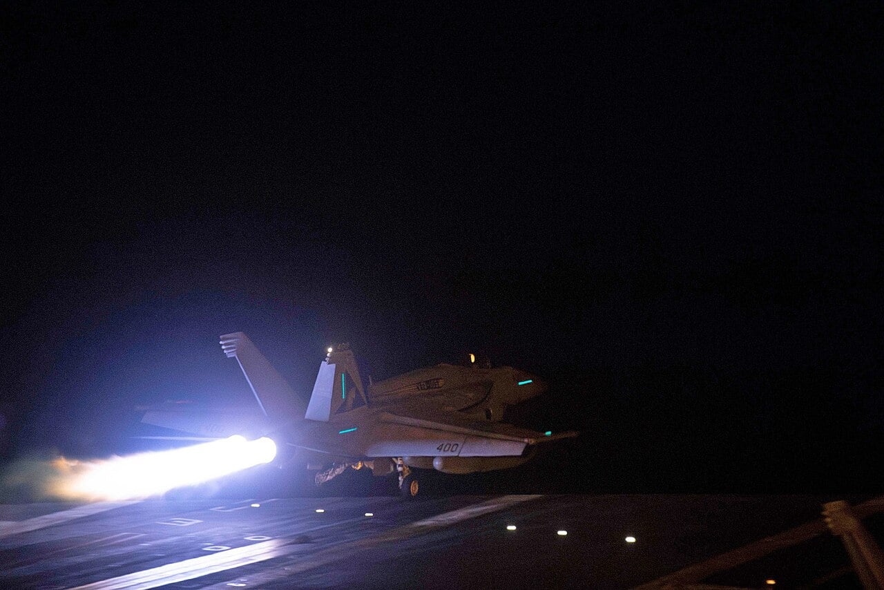 US Navy F/A-18 launching from a carrier at night before strikes on Houthi targets, 12 January 2024