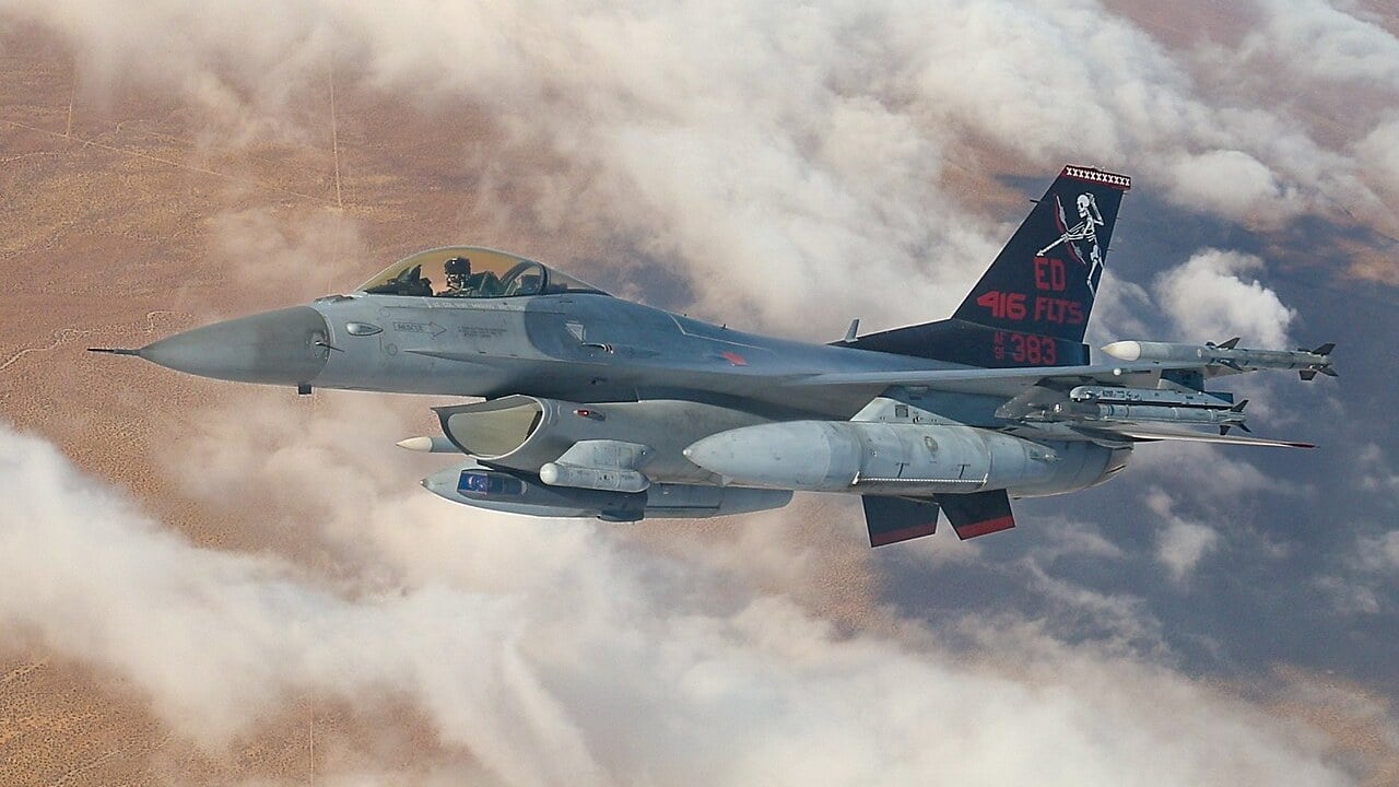 A US Air Force F-16C Fighting Falcon of the 416th Flight Test Squadron flying above clouds over Edwards Air Force Base