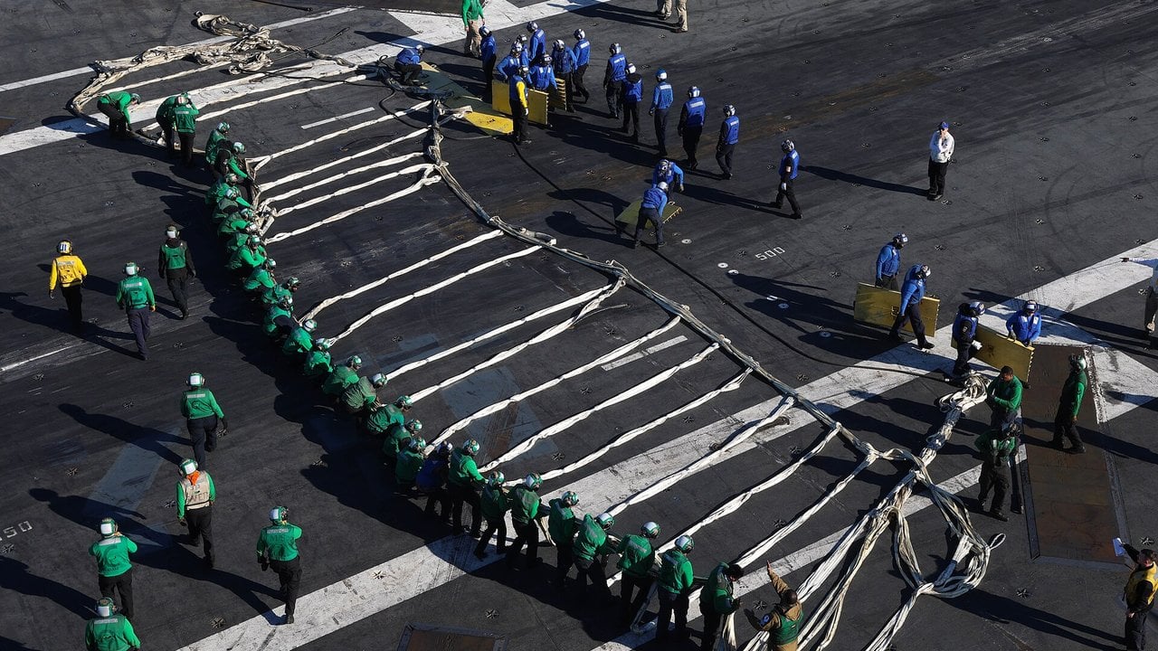 USS Gerald R. Ford barricade drill 2025 Flight deck crew lay out the nylon barricade webbing on USS Gerald R. Ford in March 2025