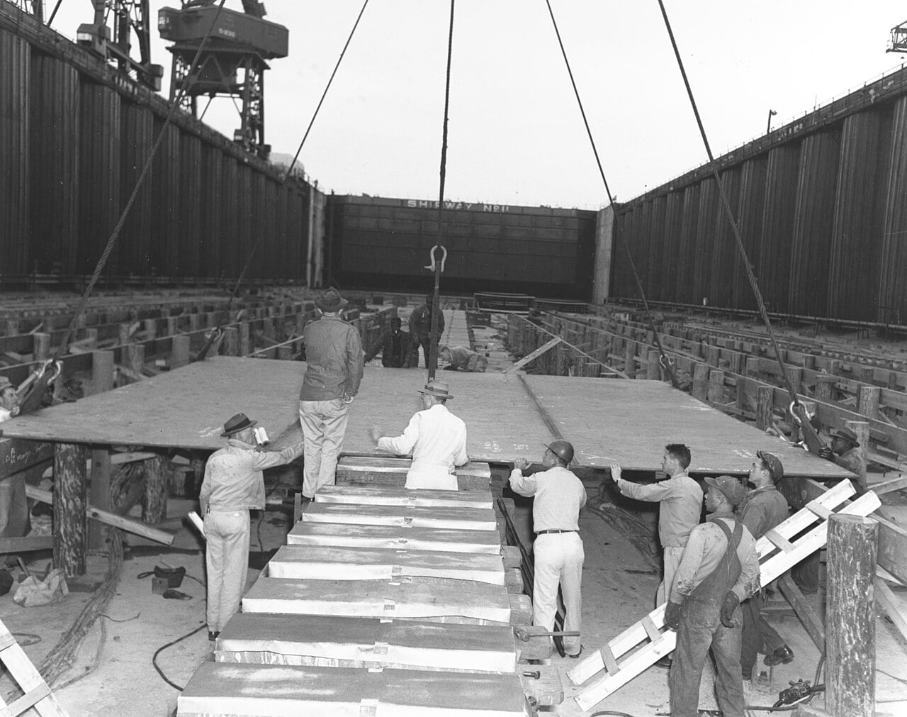 Workmen lay the keel plate of USS United States (CVA-58) at Newport News