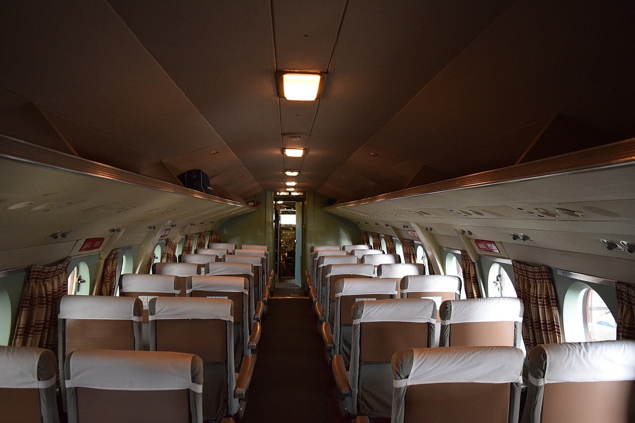 The cabin of a preserved Vickers Viscount, with rows of seats and large oval windows along both sides