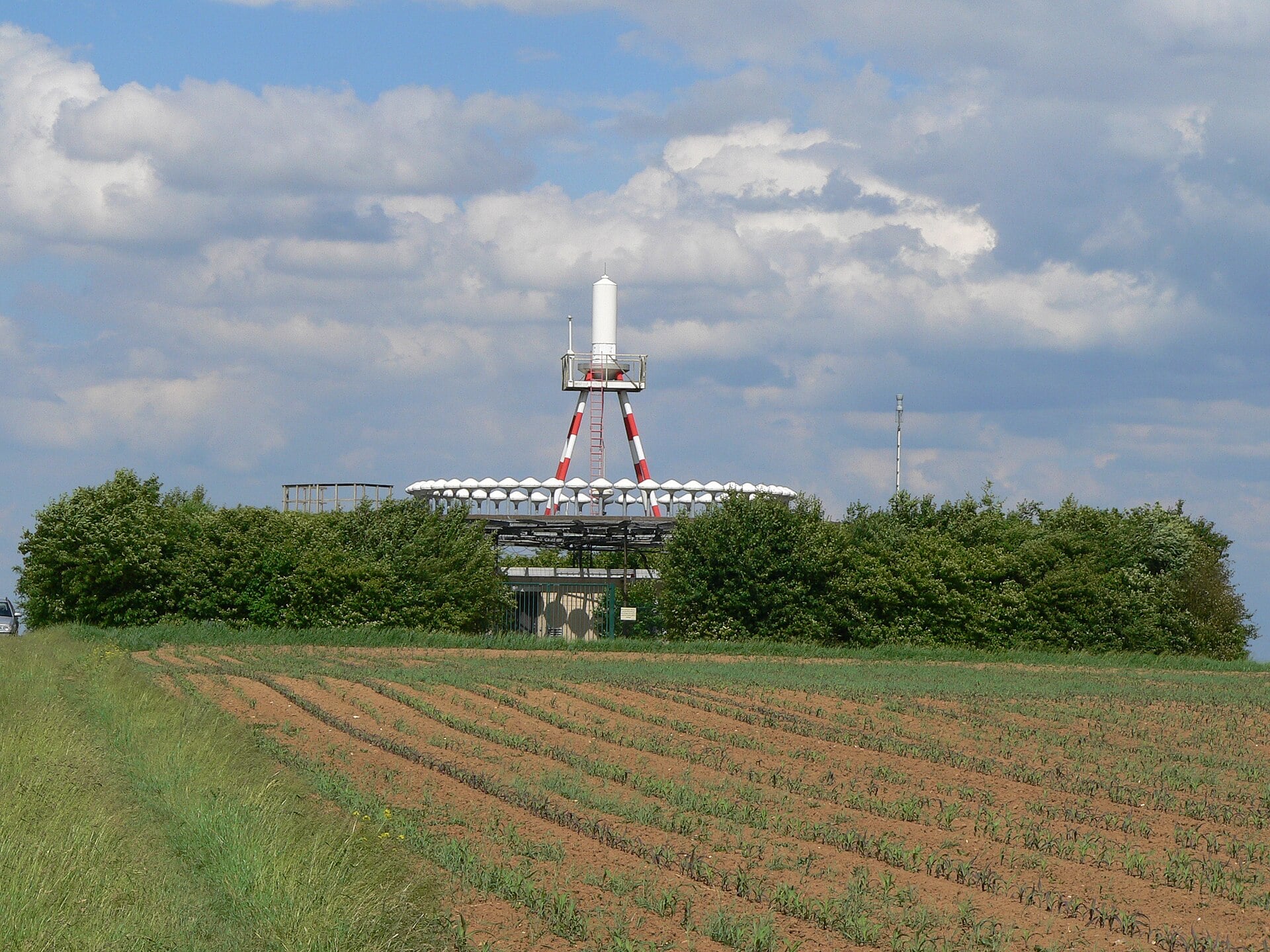 A VORTAC ground station with its circular counterpoise of antennas in open farmland
