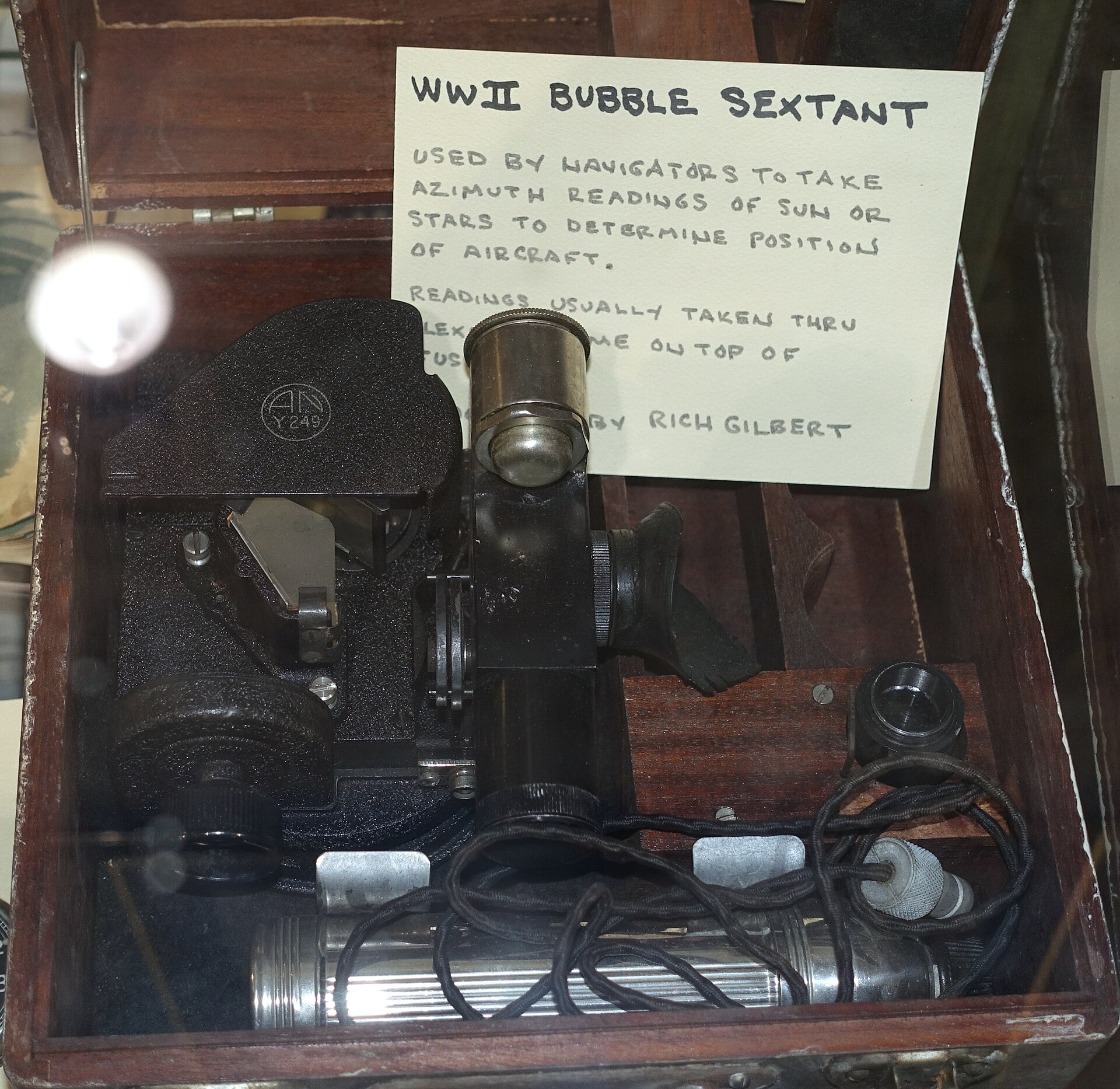 A Second World War aircraft bubble sextant in its fitted wooden case with a museum explanatory card