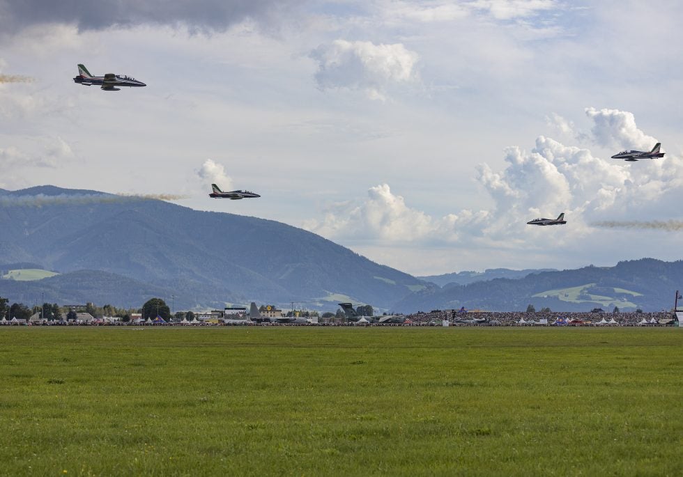 Frecce Tricolori MB-339PANs in formation, trailing green, white and red smoke.