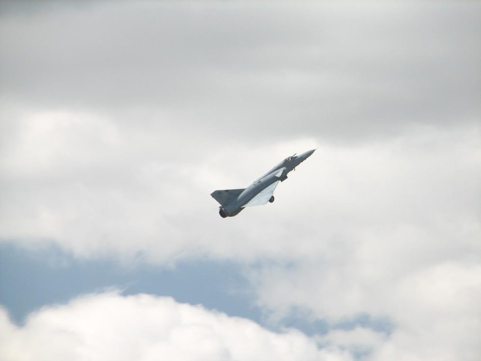 An Atlas Cheetah in flight, seen from below  the delta wing and canard layout clear against the sky.