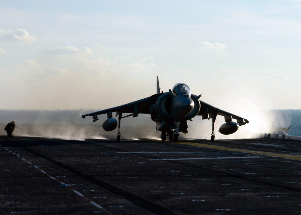 A US Marine Corps AV-8B Harrier launching from the deck of USS Kearsarge.
