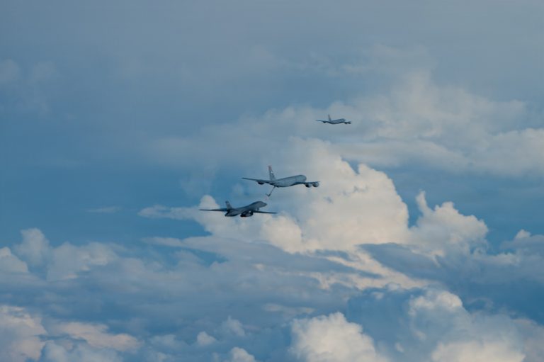 A B-1B refuels behind a KC-135 tanker how the Bone reaches intercontinental range.