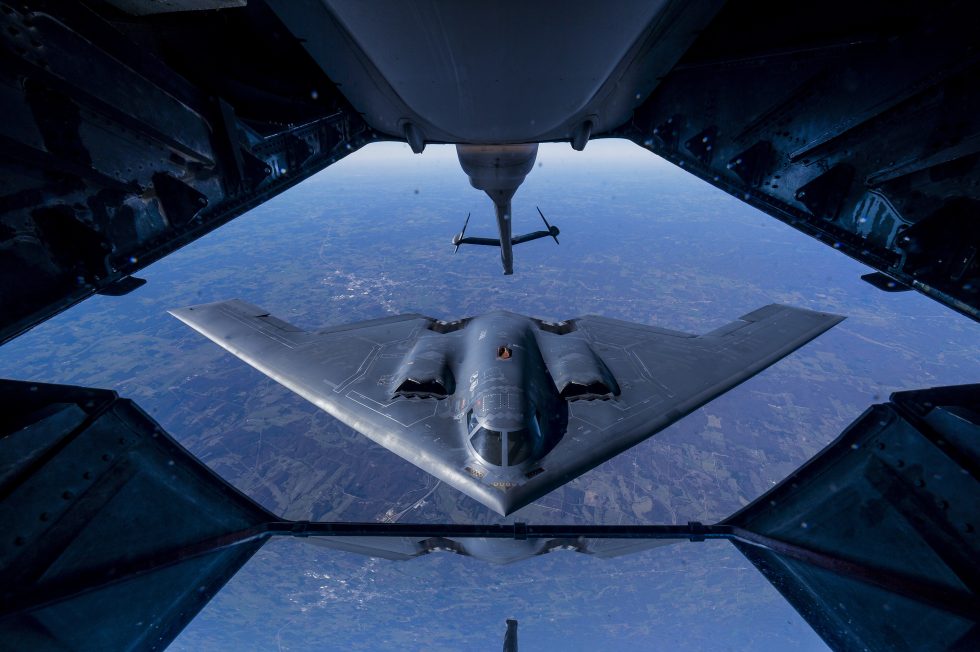 A B-2 taking on fuel in flight a single top-up extends its reach to around 10,000 nautical miles.