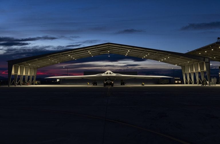 B-21 Raider inside a sunlit hangar at Edwards Air Force Base