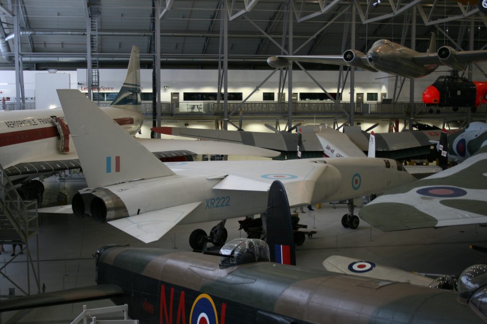XR222 seen from the rear quarter at Duxford, showing the tall fin and area-ruled lines.