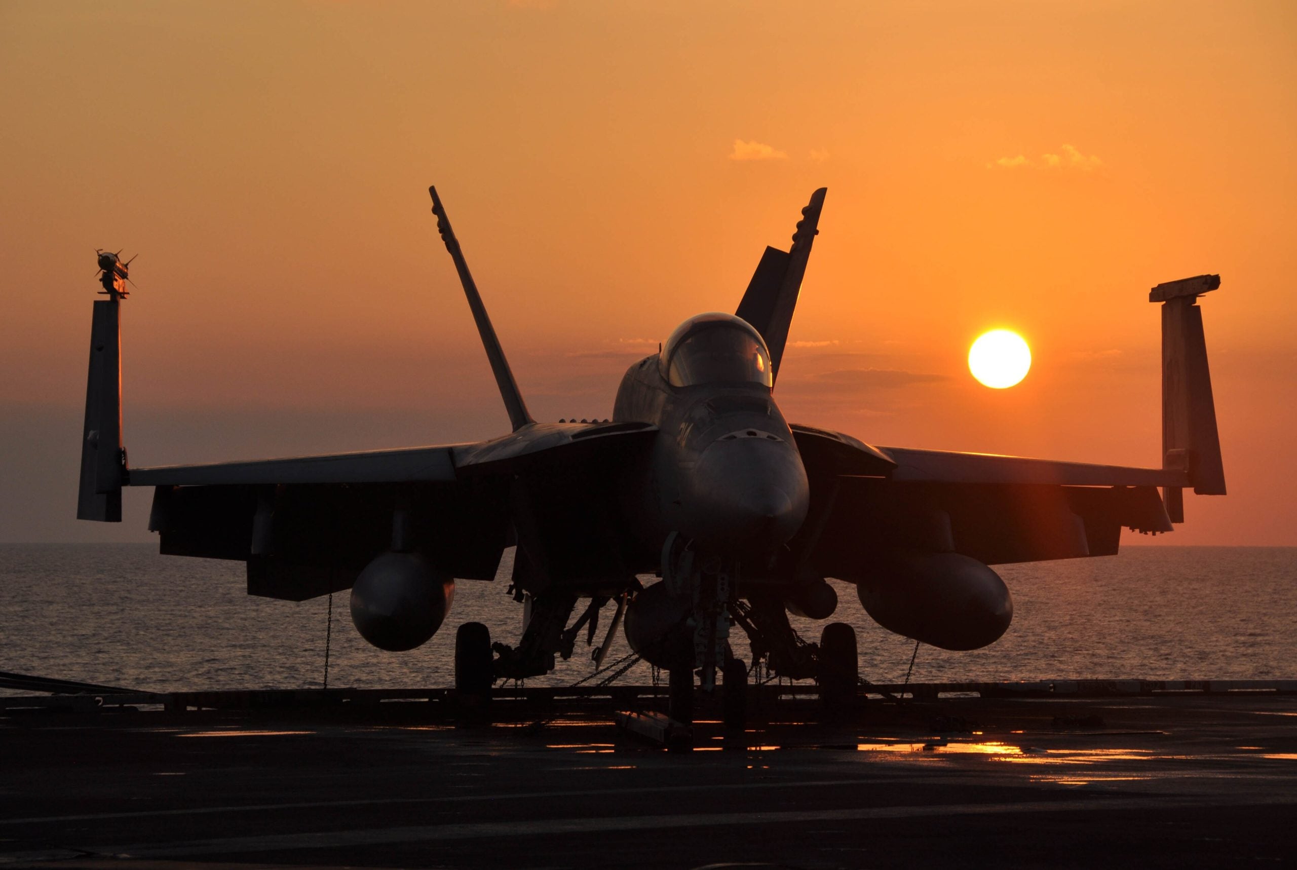 Boeing F/A-18E Super Hornet banking in flight over the ocean