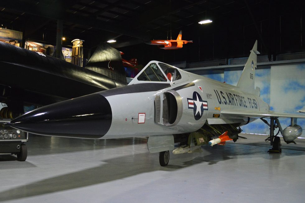 A preserved F-102A in profile the pinched coke-bottle area-rule fuselage is clearly visible.