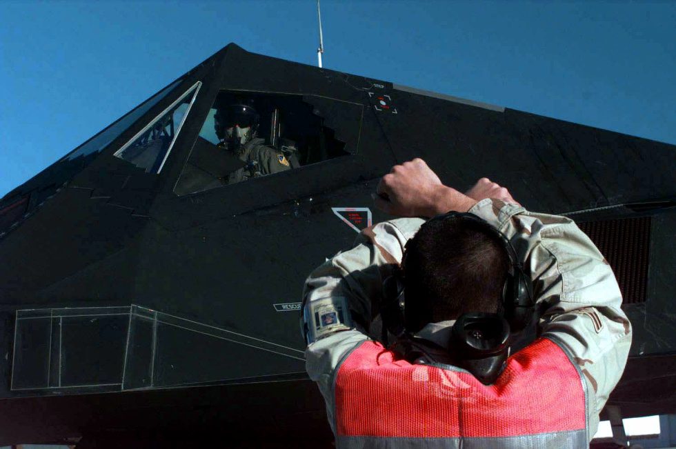 Ground crew marshals a Nighthawk deploying to the Persian Gulf in 1998  the jet flew and fought only at night.