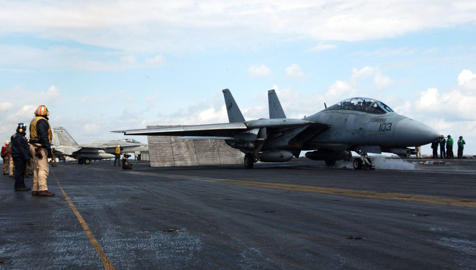 An F-14D Tomcat launches from the flight deck of USS Theodore Roosevelt.