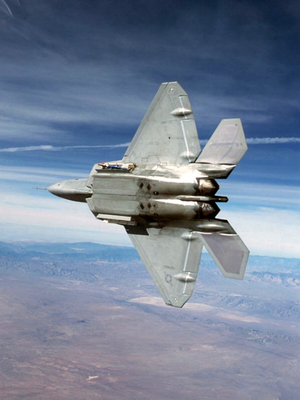 The belly missile-bay doors open, revealing the AIM-120 AMRAAMs carried inside the airframe.