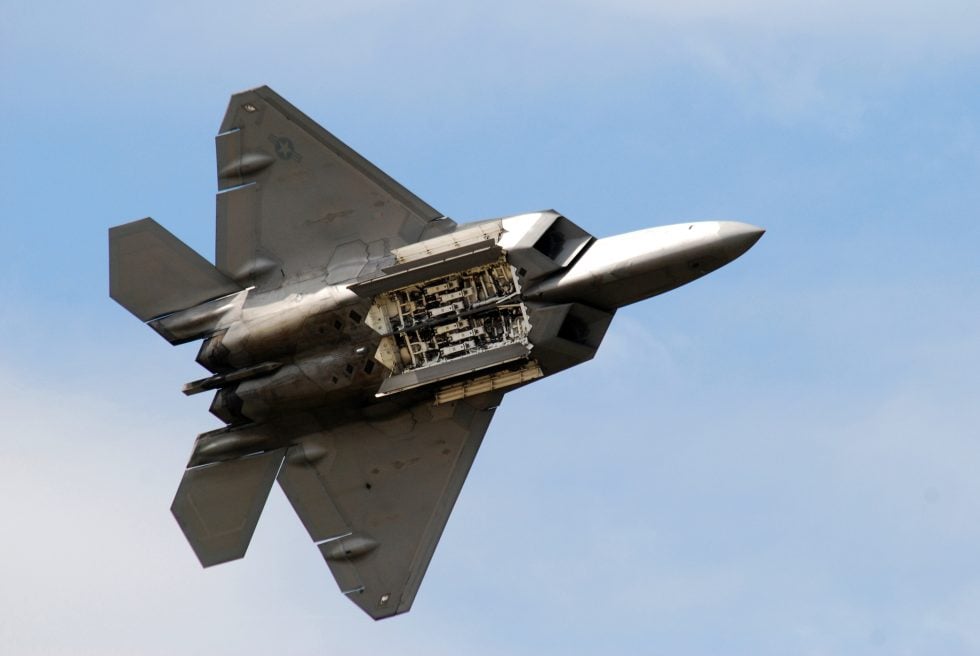 An F-22 opens a side weapon bay in flight  all weapons are carried internally to stay stealthy.