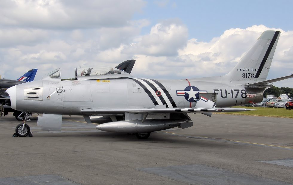 A bare-metal F-86 Sabre warbird at an airshow a handful remain airworthy in private hands.
