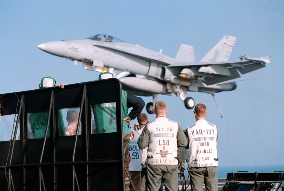 An F/A-18 Hornet catches a wire in an arrested landing aboard USS George Washington in the Persian Gulf.