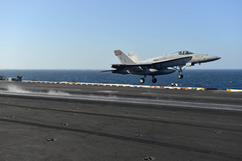 A US Marine Corps F/A-18C Hornet fires off the catapult of USS Harry S. Truman  the violent carrier launch the airframe was reinforced for.