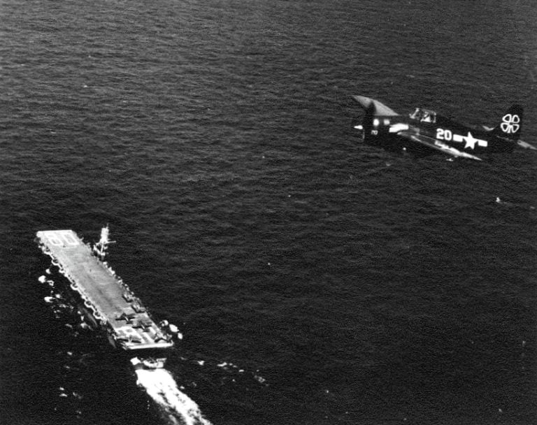 A GM-built FM-2 Wilder Wildcat over the escort carrier USS Petrof Bay, 1945.