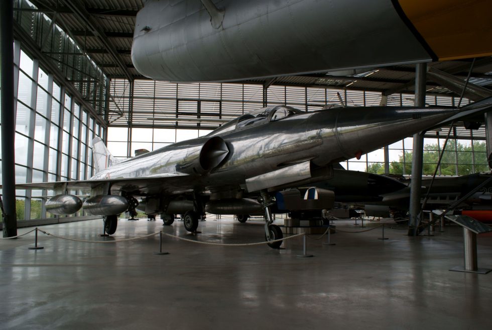 A silver Marut Mk.I on museum display  twin intakes and swept wing from the front quarter.