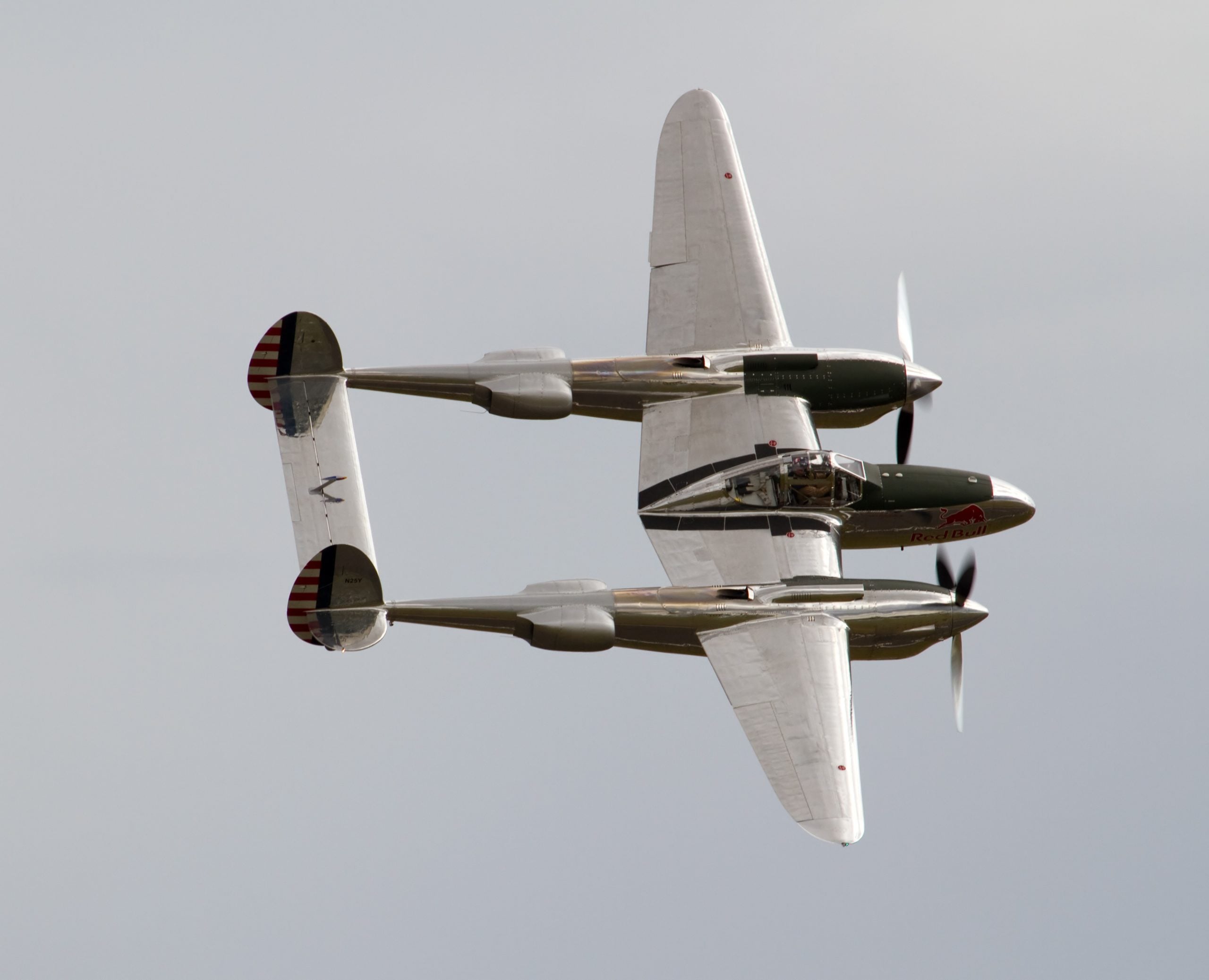 Lockheed P-38 Lightning warbird banking, showing its twin-boom layout