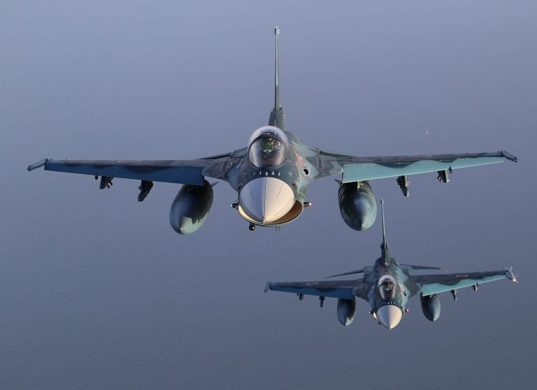 A pair of JASDF F-2s in close formation over the clouds.