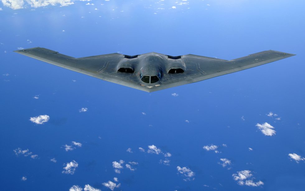 A B-2 Spirit banking in flight the tailless flying wing that gave stealth its shape.