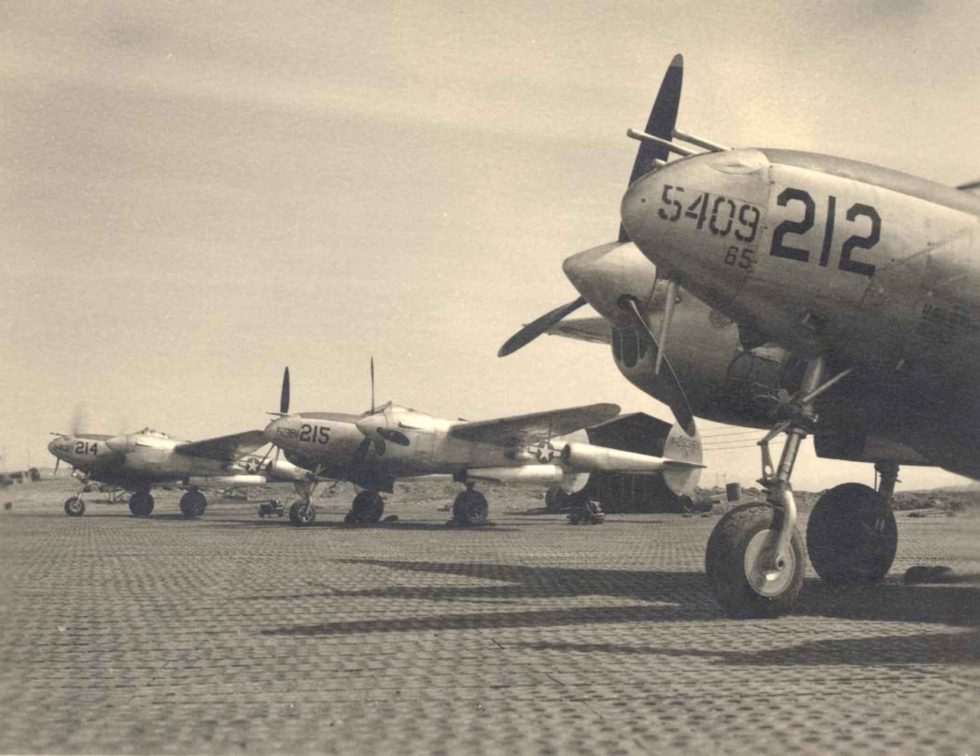 P-38 Lightnings on the flight line  the fighter that stayed in production all war.