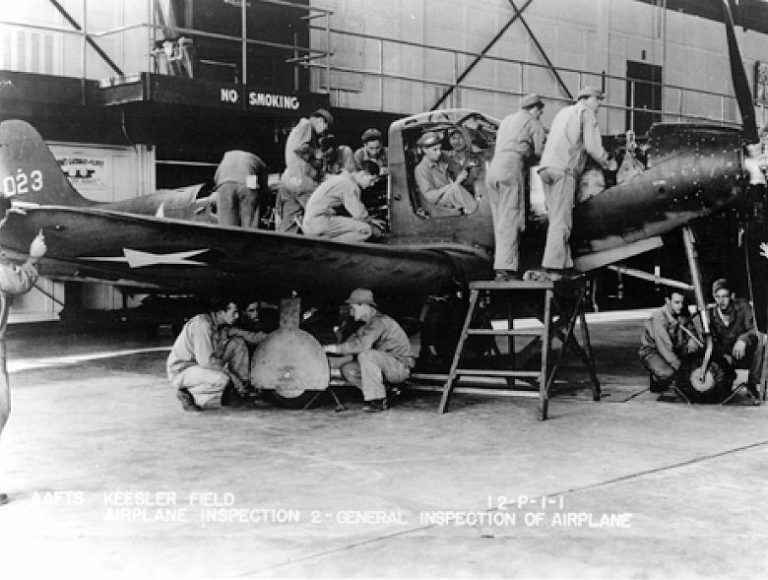 Ground training on a P-39  the car-style doors and nose-wheel gear clearly visible.