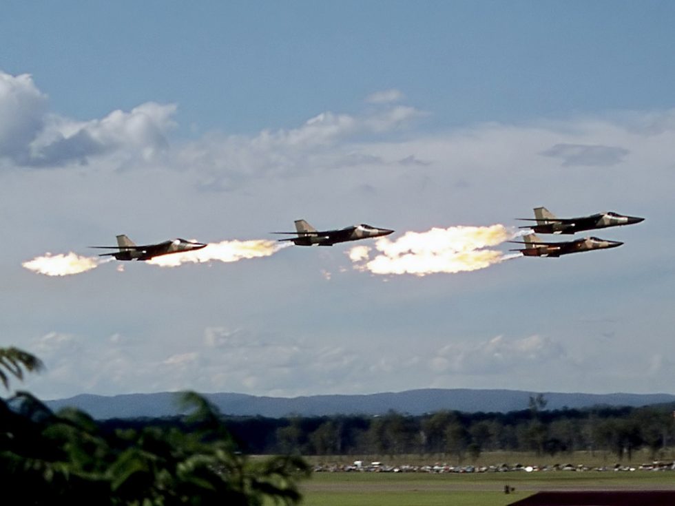 A RAAF F-111C performs the famous dump and burn fuel ignited behind the afterburners.