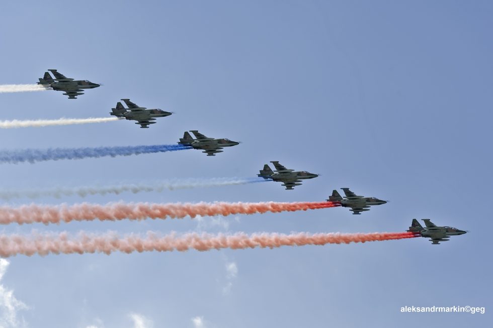 A formation of Su-25s in flight, showing the types straight wings and twin engines.