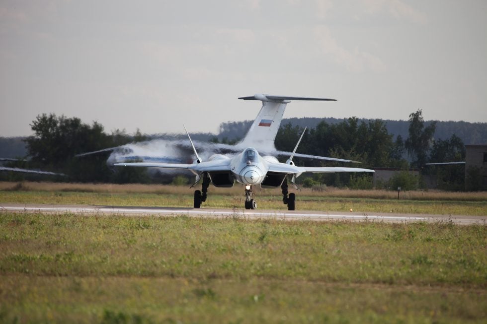 A front view of the Su-57, showing its faceted forward fuselage and widely spaced engines.