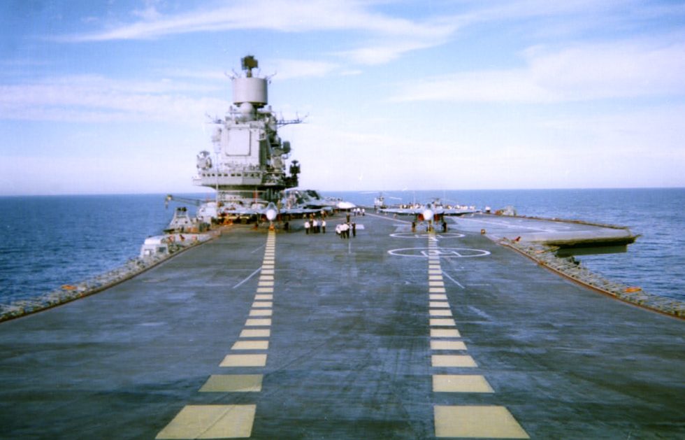 A Su-33 on the flight deck of Admiral Kuznetsov, wings spread.