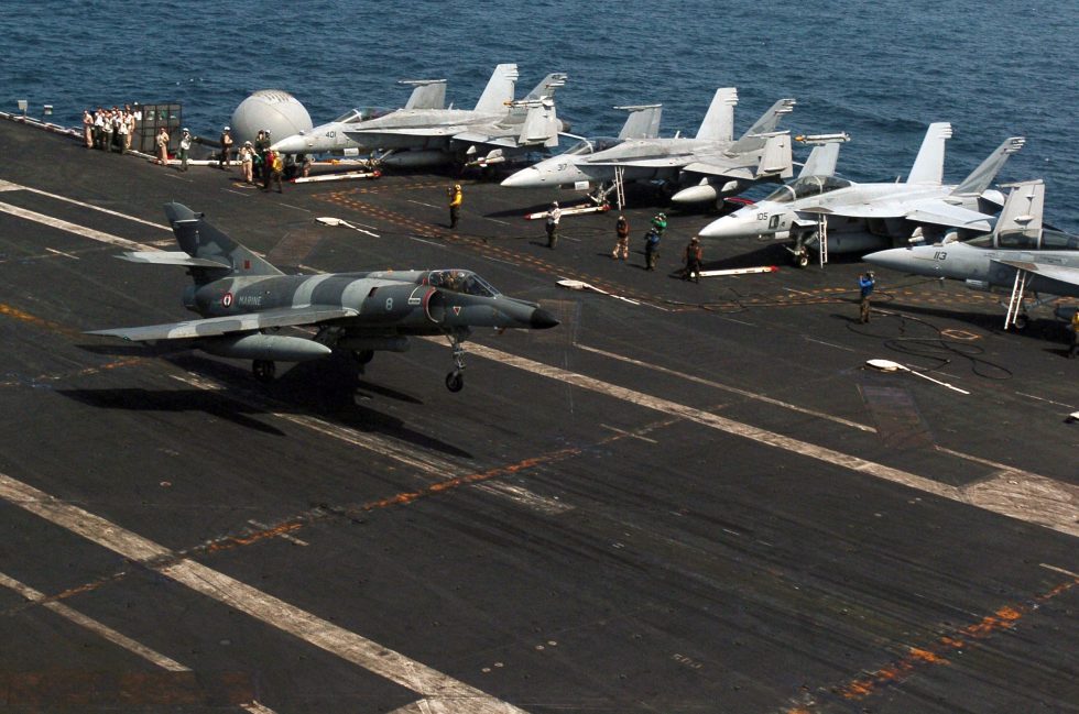 A French Super Étendard Modernisé airborne during joint carrier operations.