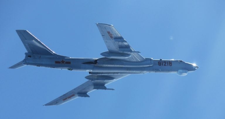 A Xian H-6 carrying underwing missiles, photographed over the sea on a maritime patrol.