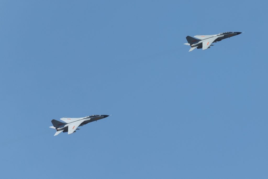 A pair of JH-7A fighter-bombers flying in close formation.