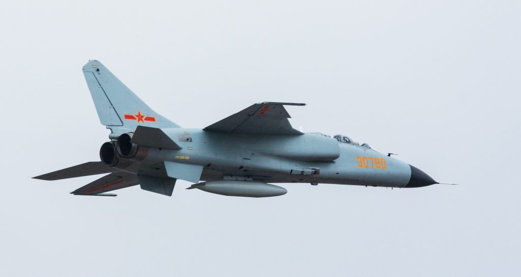 The JH-7A in side profile, showing its long fuselage and shoulder-mounted wing.