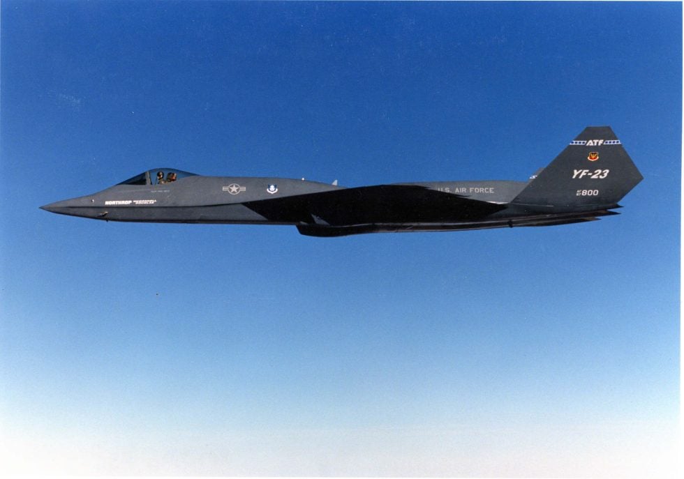 A single YF-23 in flight, showing the diamond wing planform and steeply canted V-tail that defined its stealth shape.
