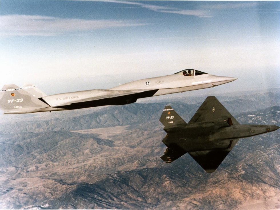 Both YF-23 prototypes in formation the charcoal PAV-1 Black Widow II and the lighter-grey PAV-2 Gray Ghost.