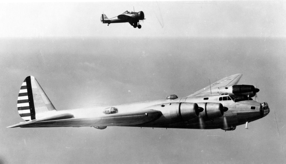 A Boeing P-26 dwarfed beside the huge Boeing XB-15 experimental bomber